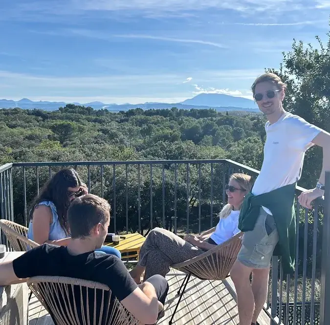 GreenGo - L’équipe GreenGo installée sur un balcon avec vue sur une forêt d’arbres.